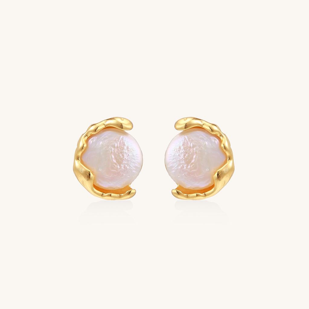 Gold-plated sterling silver stud earrings with organic claw settings cradling lustrous freshwater pearls on white background.