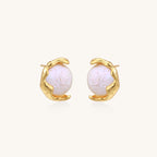 Gold-plated sterling silver stud earrings with organic claw settings cradling lustrous freshwater pearls on white background.