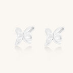 Delicate sterling silver butterfly stud earrings with intricate wing details on a neutral background.