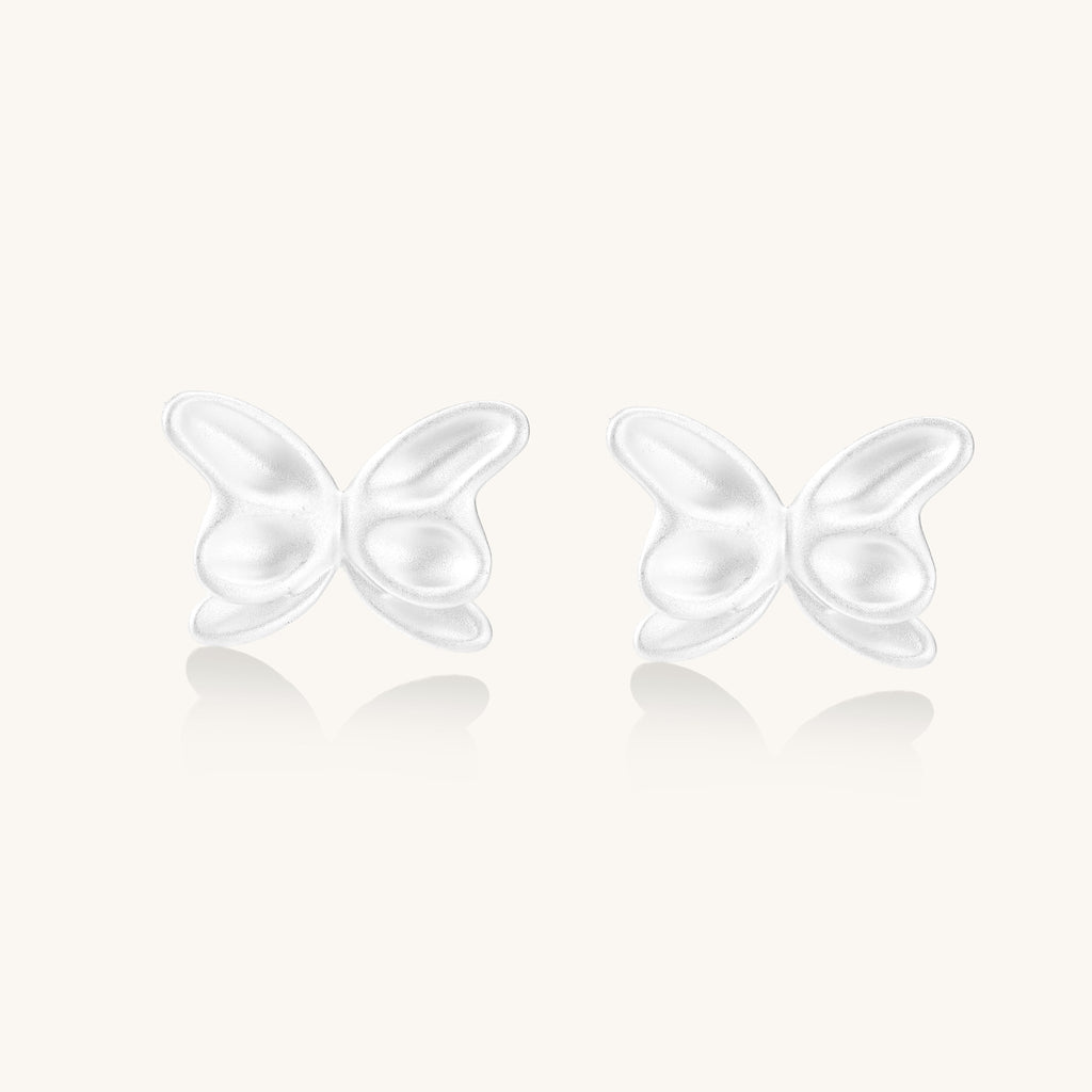 Delicate sterling silver butterfly stud earrings with intricate wing details on a neutral background.