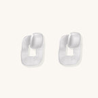 Geometric sterling silver square stud earrings with brushed texture and central square cutouts on white background.