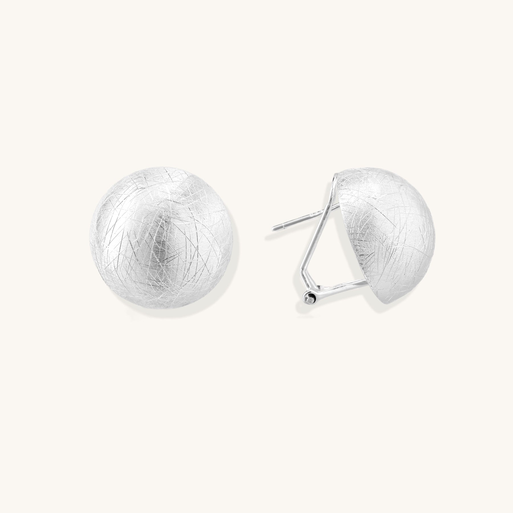 Brushed sterling silver dome-shaped stud earrings with textured surface and secure lever-back closure on white background.
