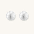 Brushed sterling silver dome-shaped stud earrings with textured surface and secure lever-back closure on white background.