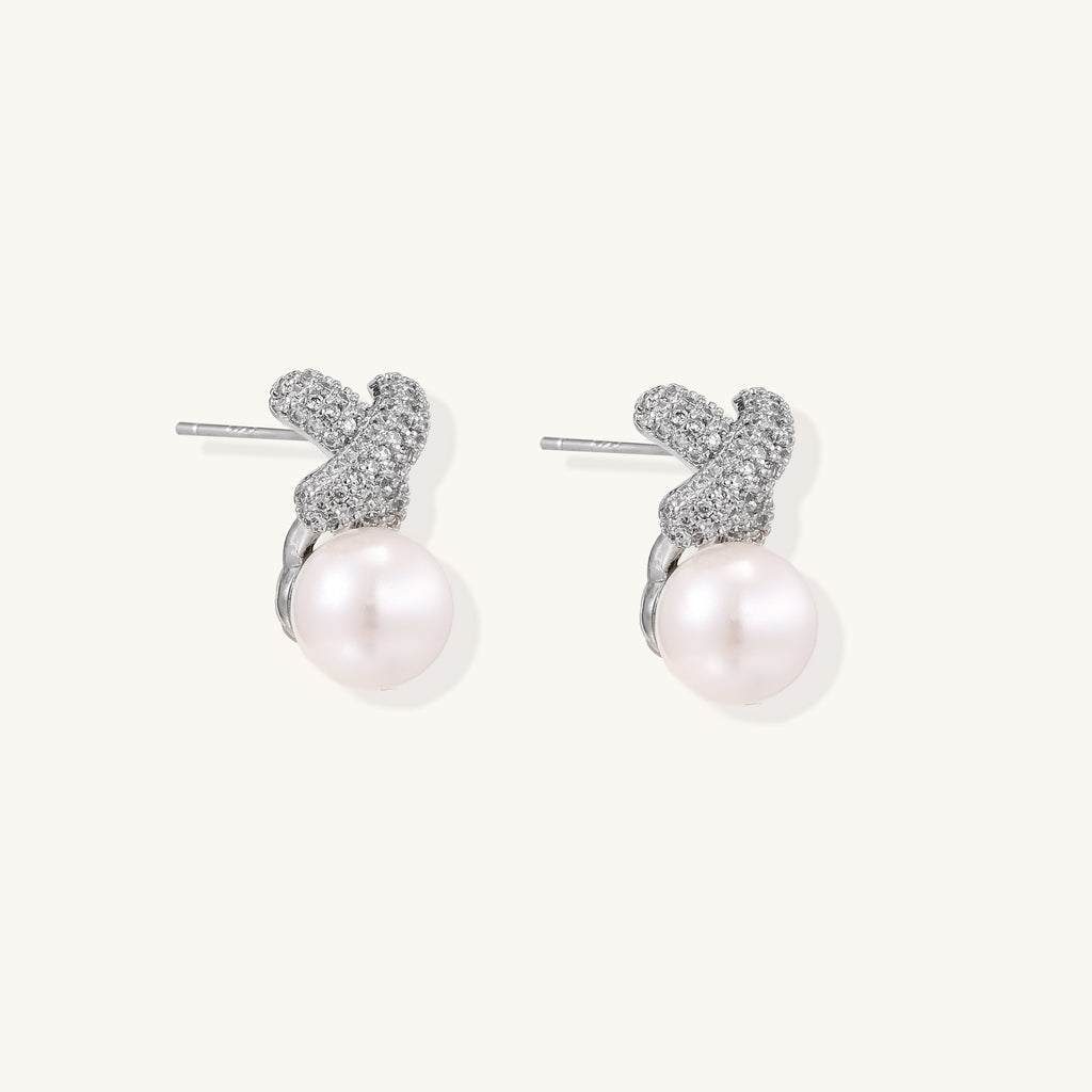 Elegant drop earrings with pavé crystal cross tops and round freshwater pearls on 14K gold plated brass setting.