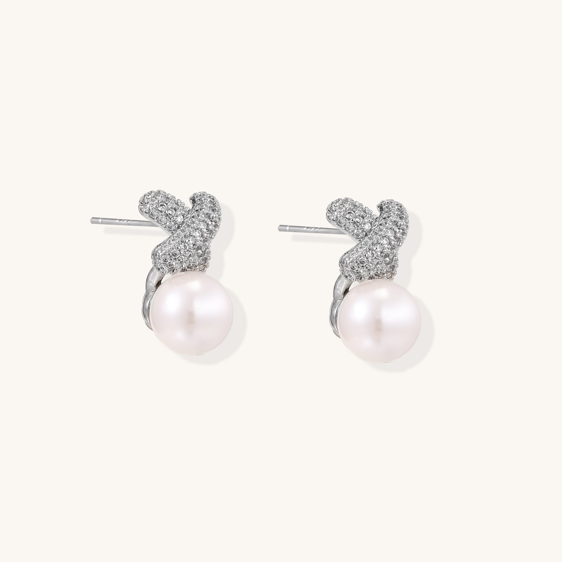 Elegant drop earrings with pavé crystal cross tops and round freshwater pearls on 14K gold plated brass setting.