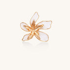 Gold-plated adjustable ring with large white enamel flower design featuring smooth petals outlined in gold