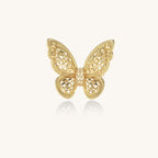 Adjustable gold-plated brass butterfly ring with intricate filigree cutout patterns and cubic zirconia accents on white background.