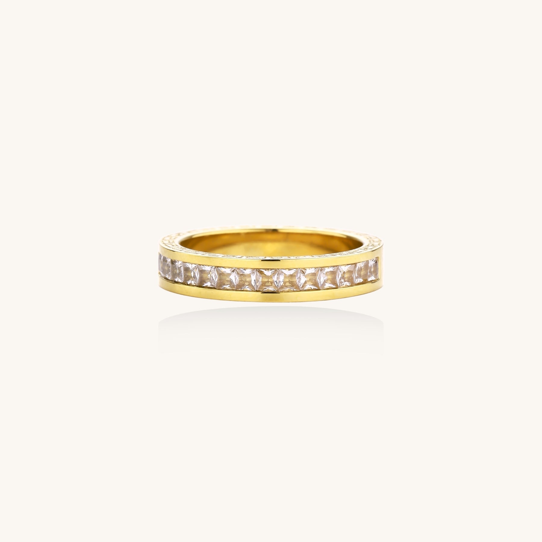 14K gold plated ring with channel-set zirconia stones and Greek key pattern engraved on sides on white background