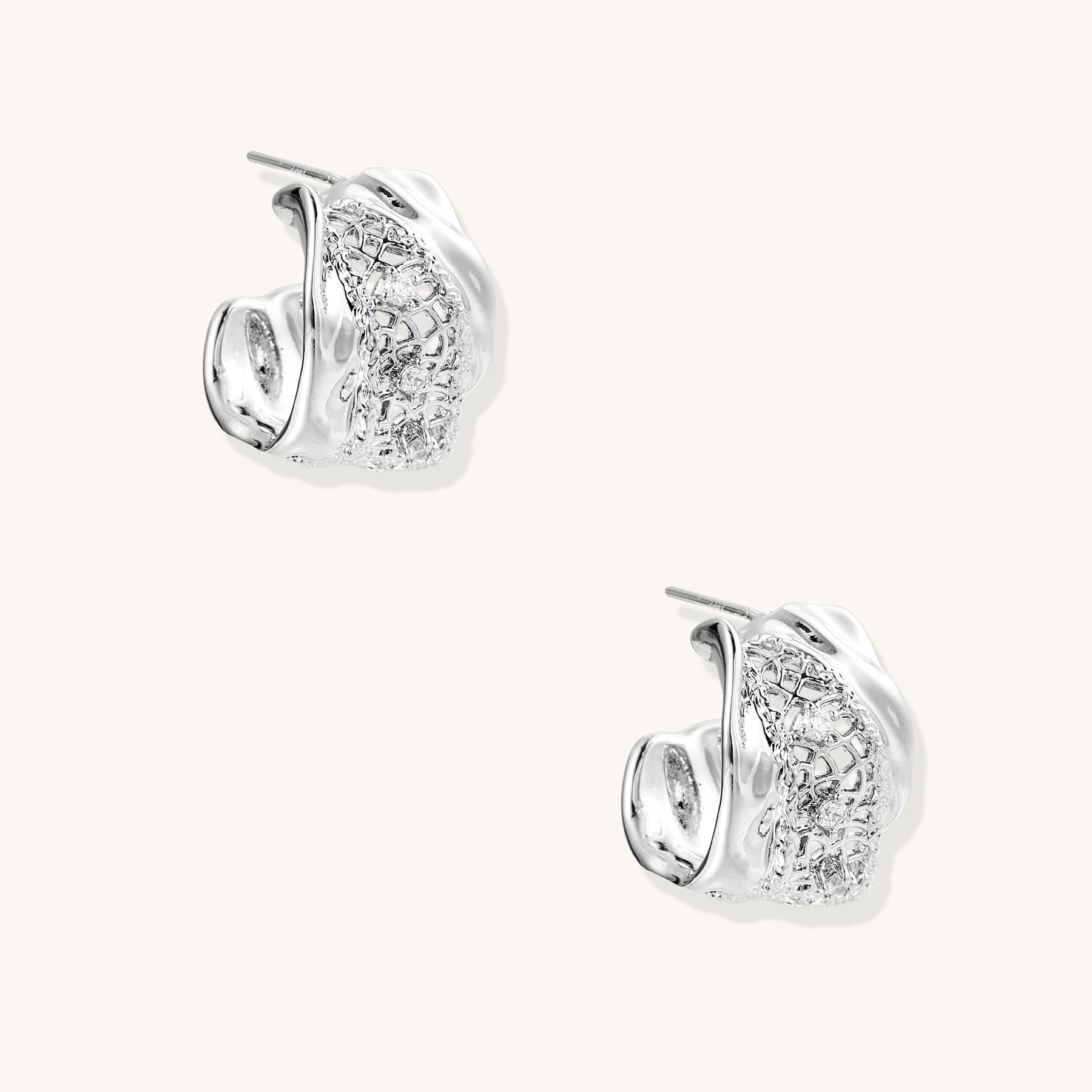 Small gold-plated brass hoop earrings with geometric lattice pattern and zirconia accents on white background.