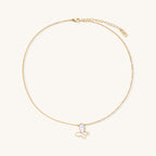 Delicate gold butterfly necklace with white mother of pearl wings on fine chain, displayed on neutral background.