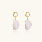 18K gold vermeil twisted circle studs with organic white baroque pearl drops on cream background